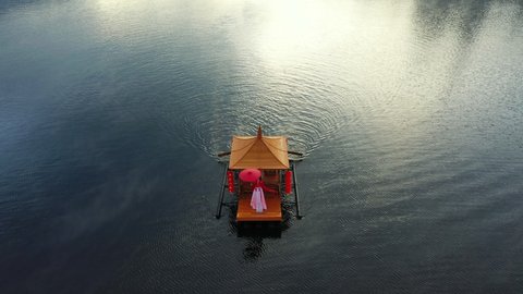 Asian woman wearing chinese traditional dress on a boat at Ban Rak Thai village, Mae hong son province.