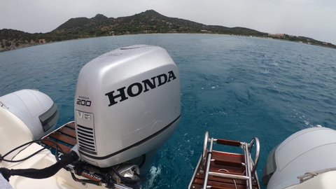 Villasimius, Italy 23-06-2021; Honda BF200 outboard on a dinghy performing a quick acceleration from a standstill. Offshore acceleration test. Propeller engine at maximum power at sea. 