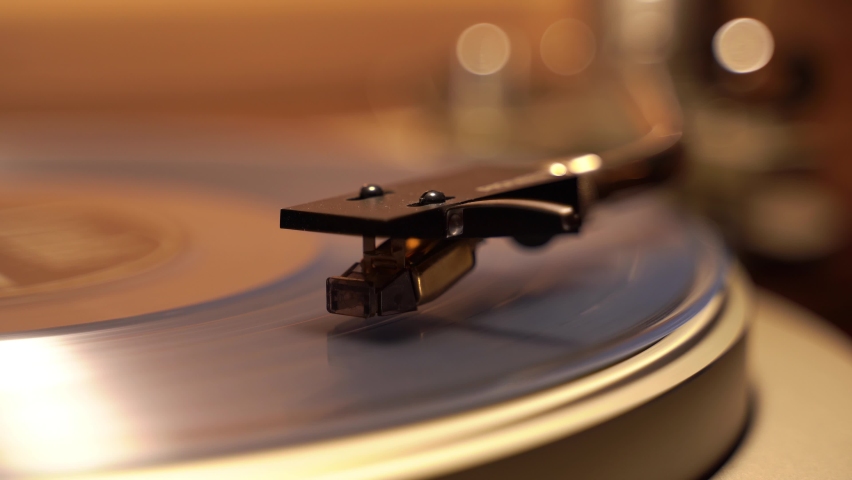 Close-up of a turntable head that rides on a blue vinyl plank | Shutterstock HD Video #1074776801