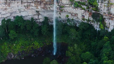 Aerial view of the magnificent beautiful clear water of Gudu Falls surrounded by lush green forest and plunge pool below in the Drakensberg mountains, KwaZulu-Nata,South Africa