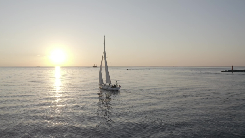 The yacht in the sea goes to meet the sunset | Shutterstock HD Video #1074782696