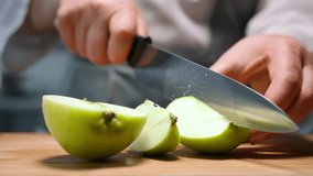 Female hands cut green apple in pieces. Close up - Powered by Shutterstock - Get 15% off with code: PIKWIZARD15