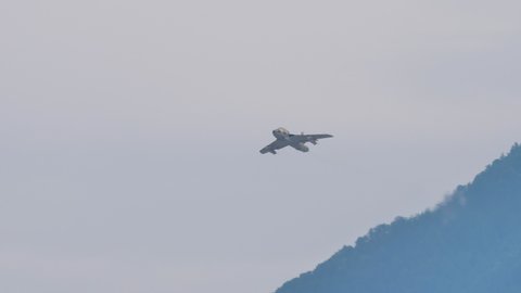 Mollis Switzerland AUGUST, 16, 2019 Vintage combat jet aircraft of the 1950s and 1960s in flight in a grey sky. Hawker Hunter vintage fighter jet of Swiss Air Force in 4K