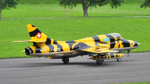 Mollis Switzerland AUGUST, 16, 2019 Vintage combat airplane taxies on the runway of a military airport in 4K. Hawker Hunter vintage fighter jet of Swiss Air Force in 4K