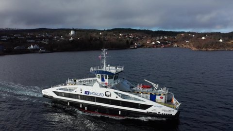 Aerial shot over Electric passenger ferry sailing through open fjord - Norway