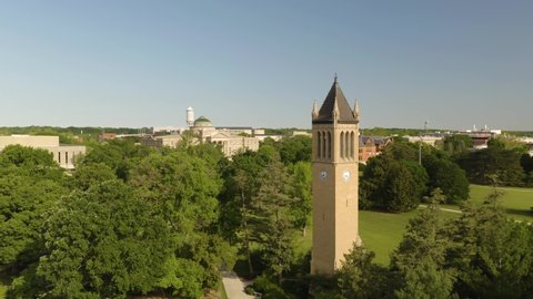 Ames , Iowa , United States - 06 12 2021: Iowa State University Bell Tower, Beardshear Hall, Campus Lawn, Beautiful Aerial Establishing Shot