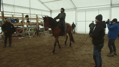 Prague , Czech Republic - 01 17 2021: Horse bucks off stuntman who does falling back flip, behind the scenes rehearsal