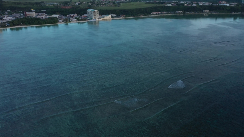 peaceful sunset in agana bay in Guam via drone.