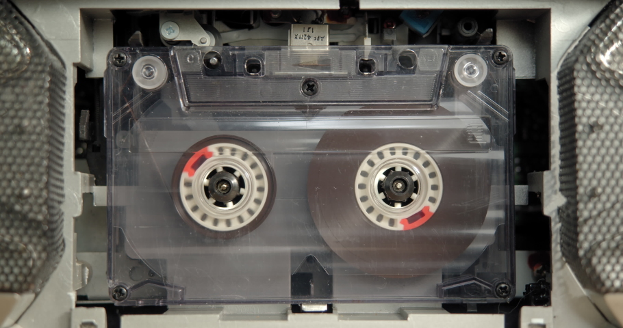 A male hand inserts an tape cassette into an old player. Disused, obsolete but nostalgic musical equipment and audio recordings., a Technology Video by Stanislav Lunev