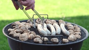 4K 60fps video of grill mashrooms champignons and sausages made on backyard