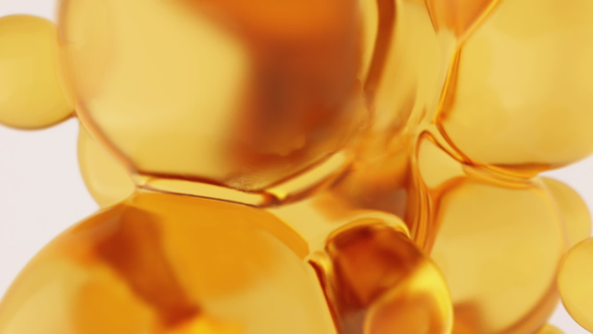 Oil yellow orange abstract background with round golden spheres close up. Footage for trade of vegetable, fish oil or machine. Royalty-Free Stock Footage #1074803957