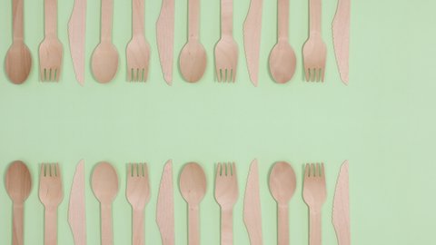 6k  Eco friendly zero waste eating utensil made of bamboo wood on two sides of green theme. Stop motion