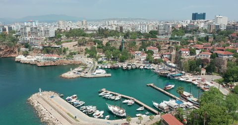 Aerial view. Antalya bay in Antalya city from high point of drone fly on sunny day in Turkey. Amazing aerial cityscape view from birds fly altitude on beautiful town and sea full of yachts.