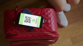 Vaccination passport on a mobile phone allowing travel in suitcase. Top view - Powered by Shutterstock - Get 15% off with code: PIKWIZARD15