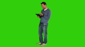 Chromakey footage of a casual man holding a touch pad