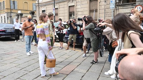 Milano, Italy - June 20, 2021: A woman poses for photographers with her street-style outfit outside the Etro catwalk show during the Mens Milan Fashion week