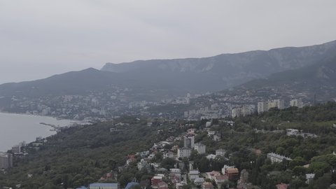 D-Log. Yalta, Crimea. Panorama of the city in sunny weather. Embankment and port, Aerial View
