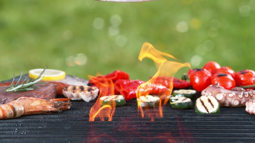 Super slow motion of falling raw mackerel on grill grid. Filmed on high speed camera, 