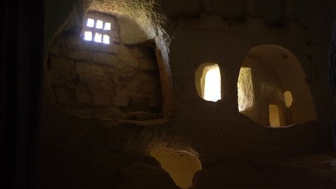 Ancient architecture in Turkey, Cappadocia. Sunlight through window holes inside of amazing ancient cave church carved in volcanic mountains