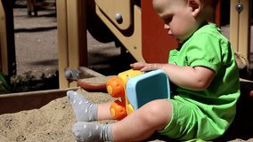Adorable caucasian baby boy playing with car.