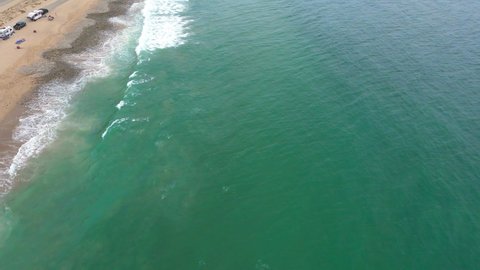 Flying Along Shoreline in Malibu, Aerial Shot Ocean Waves Crashing against Sand, Cars Moving along Highway