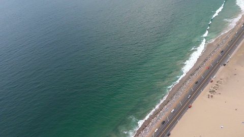 Drone Shot over Pacific Coast Highway, Blue Green Pacific Waves Crashing into Highway