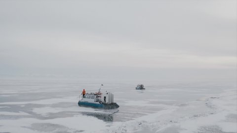 khivus on a hovercraft rides on the frozen lake Baikal, a trip to Russia. High quality 4k footage