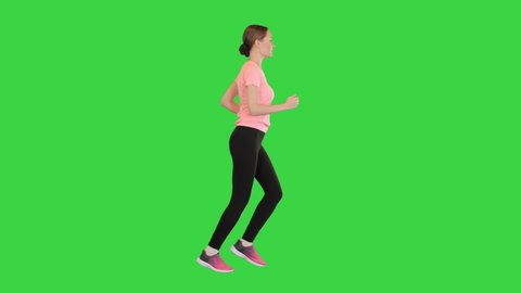Woman in a pink t-shirt running on a Green Screen, Chroma Key.