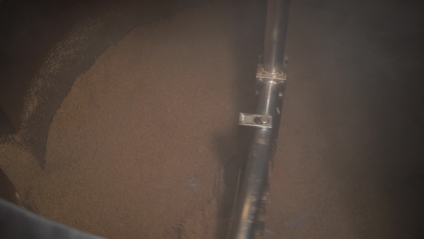 Modern brewery. Beer in the tank for brewing whirls in a whirlpool, mixed. The process of