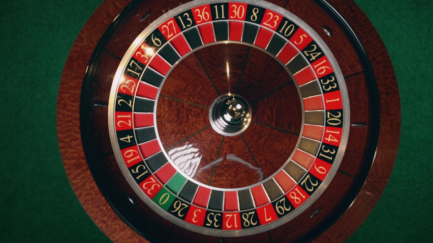 Close up of roulette wheel at the casino in motion. The wheel ball is spinning. Concept of casino and gambling. 4k background Royalty-Free Stock Footage #1074865946