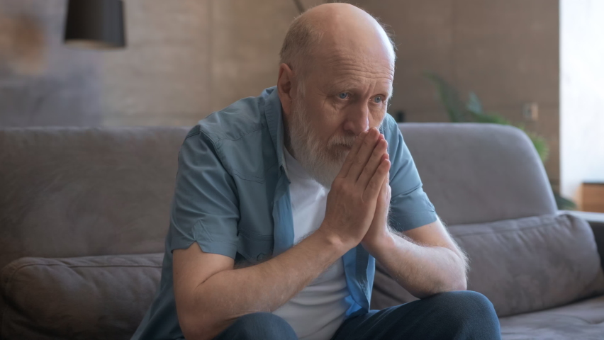 Sad old man sits alone remembering his past life, widower mourns his wife, feels unhappy, immersed in sad thoughts, health problems, personal difficulties, loneliness, depression, parkinson's disease. Royalty-Free Stock Footage #1074867605
