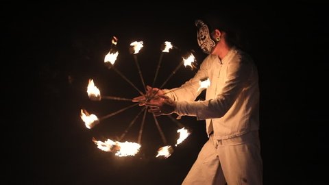 A man fire show or fire performance is juggling burning for wedding party's on the Maui beach.
