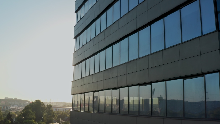windows of empty offices of modern mirrored business center during covid-19 pandemic isolation. window view of the deserted floors of a mirrored office building Royalty-Free Stock Footage #1074885293
