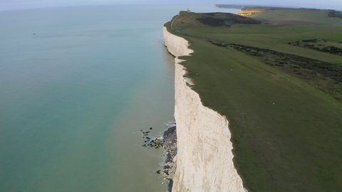 Aerial shot flying along with the seven sisters on the south coast of England in East Sussex with huge chalk cliffs, near Eastbourne.