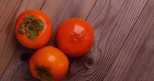 Video of turning three persimmons on a board.