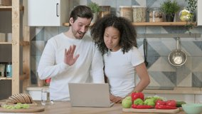 Mixed Race Couple Doing Video Call on Laptop in Kitchen