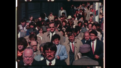 1980s New York City. Crowded New York City Street. A large group of People Commute on City Sidewalk. 4K Overscan of Vintage Archival 16mm Film Print
