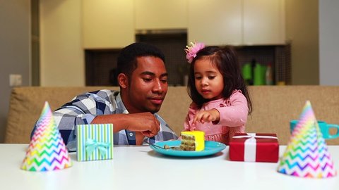 mixed race family habing birthday party in kitchen