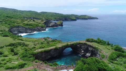 Aerial view by drone overlooking the sea. Rocky coast with high cliffs, Beach with hole on the cliff in Nusa Penida island, Bal Pasih Uug, Broken Beach, angels billabong. Bird eye view