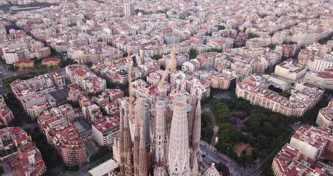 BARCELONA, SPAIN- JUNE 13, 2019: Aerial view of Sagrada Familia on background of Eixample district cityscape 
