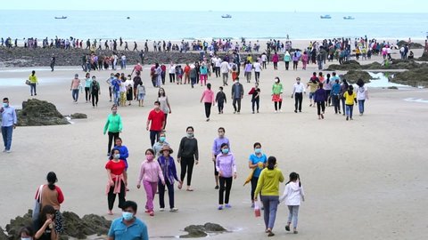 Vung Tau, Vietnam - February 25th, 2021: Pilgrims walk across island to temple to worship goddess for peace their families on full moon day of first lunar month in Vung Tau, Vietnam.