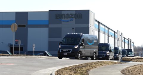 Columbus , OH , United States - 03 29 2021: Amazon vans pull out of Amazon warehouse in Columbus, Ohio