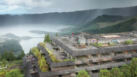 SAO MIGEL ISLAND, AZORES, PORTUGAL-14 MAY, 2021: Aerial view of tourists walking in roof of abandoned Monte Palace hotel ruins, Cerrado das Freiras, Sao Miguel island, Azores ,Portugal, 4k footage