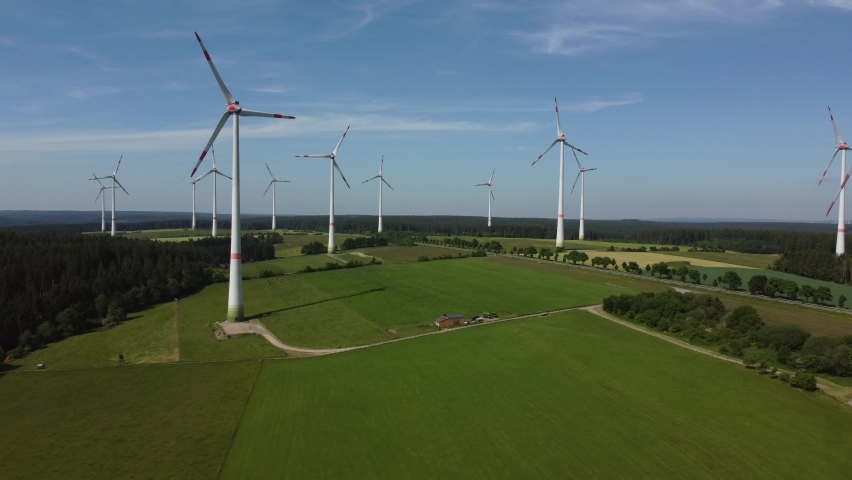 Drone shot of windmills in Germany. Green and sustainable energy. Peaceful and quiet scenery on a summer day. | Shutterstock HD Video #1074957527