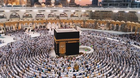 Kaaba the Holy mosque in Mecca with Muslim people pilgrims of Hajj praying in crowd. (time-lapse)