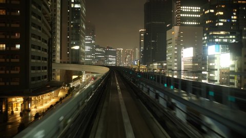 POV View of an Automated Train Running Through a Big City in the Evening (Real Time) Arkivvideo
