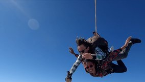 Tandem parachute jump video. Beautiful Brazilian woman.	