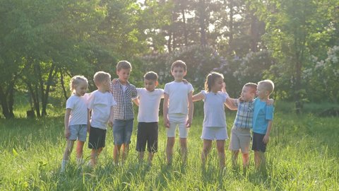 Slow-motion video. A group of children are standing in the park