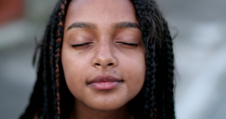 Happy hispanic black girl child opening eyes to sky looking up Royalty-Free Stock Footage #1074975035