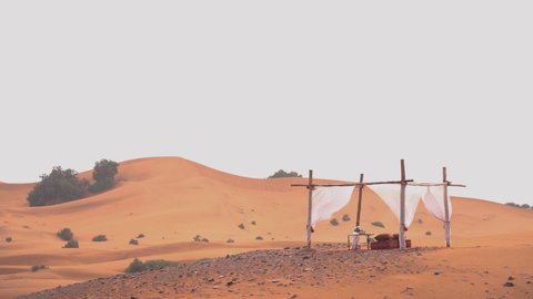 WS, establishing shot of the golden Sahara dunes on a windy and rainy